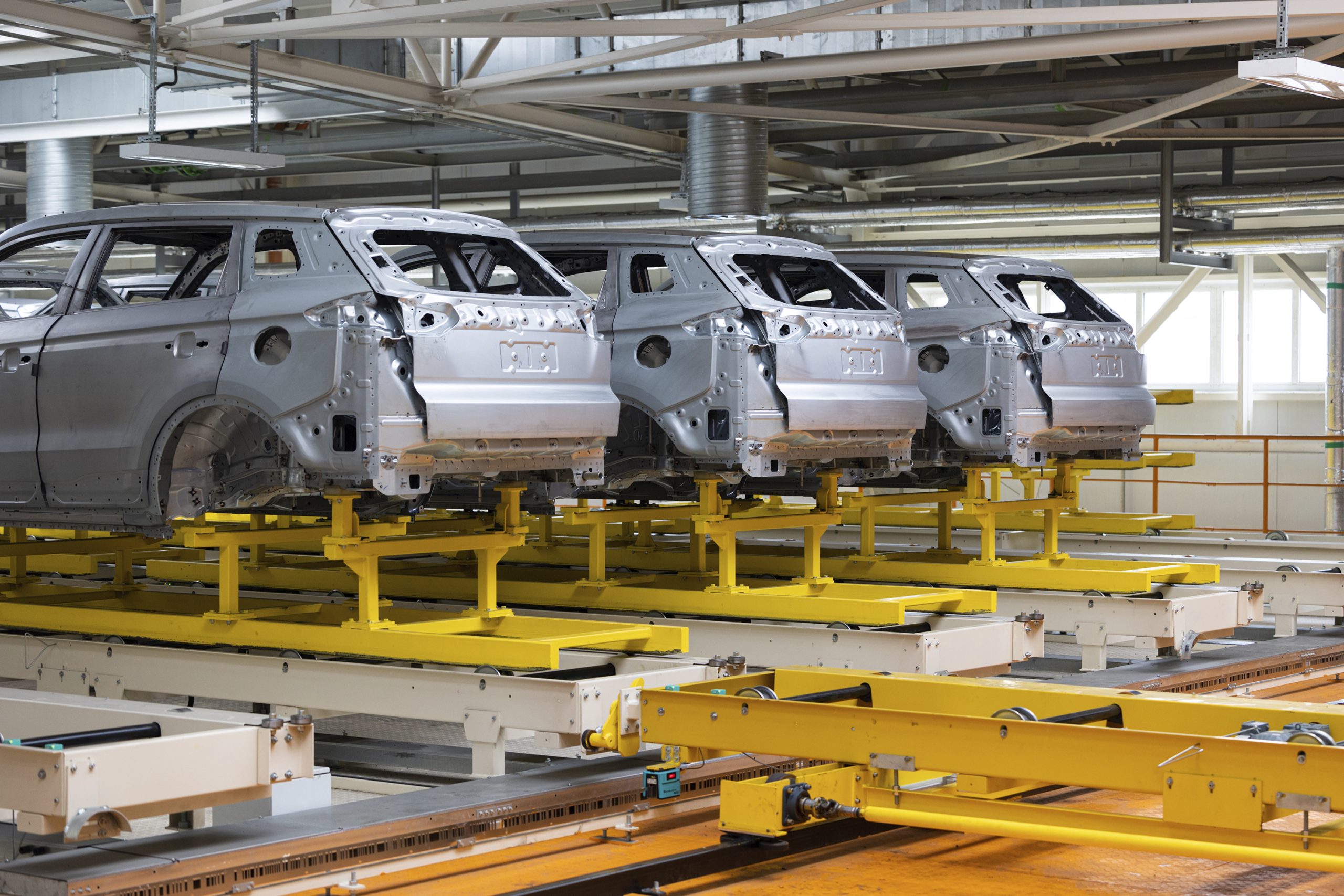 Photo of automobile production line. Welding car body. Modern car assembly plant. Auto industry. High-tech factory Photo of automobile production line. Welding car body. Modern car assembly plant. Auto industry. High-tech factory